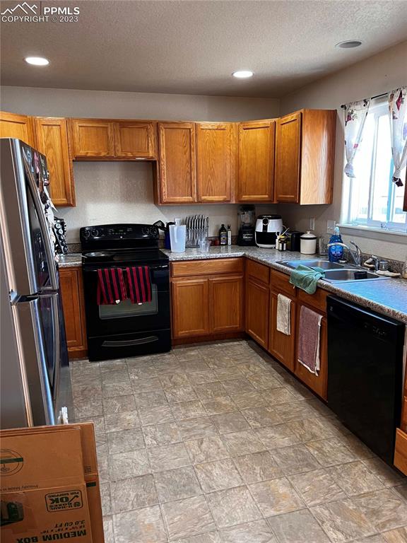 6350 Dancing Moon Way Colorado Springs, CO 80911 - Photo 10 of 12 a kitchen with stainless steel appliances granite countertop a stove sink and cabinets
