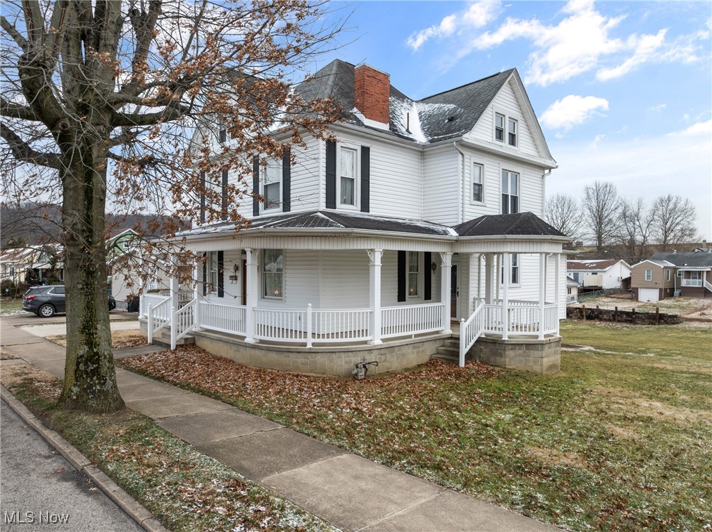 1011 Parriott Avenue Moundsville, WV 26041 - Photo 3 of 44 View of front facade featuring covered porch, a front yard, and a shingled roof