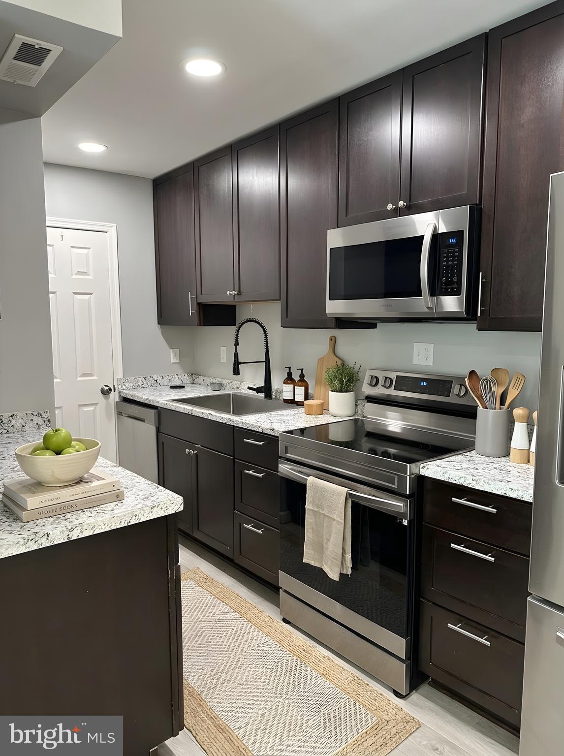 5900 Prince George Drive, Unit 333 Springfield, VA 22152 - Photo 4 of 31 a kitchen with a sink stove and microwave