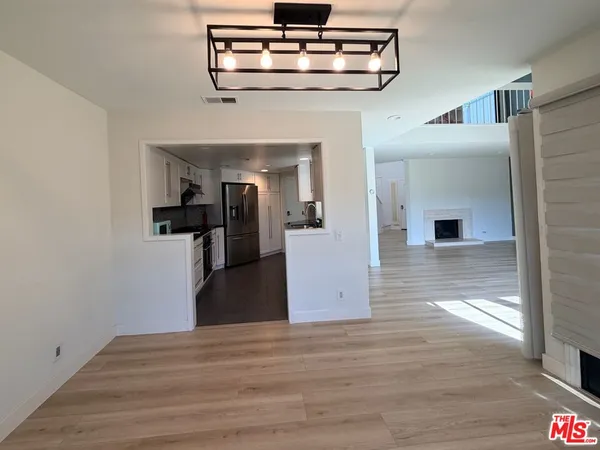 a view of a hallway view with wooden floor and staircase