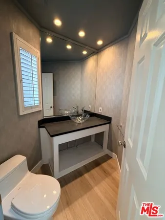 a bathroom with a toilet a sink and a mirror