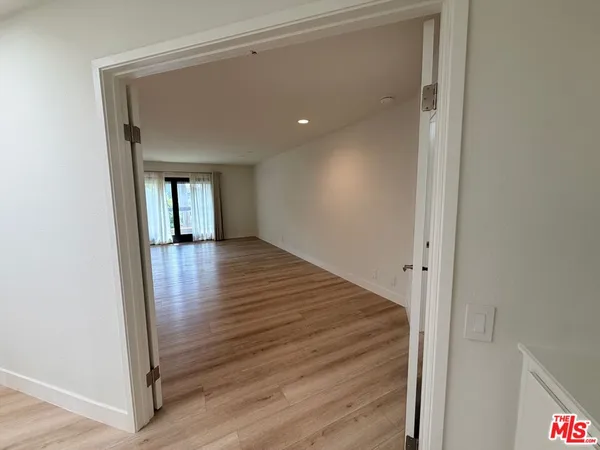 a view of a hallway with wooden floor