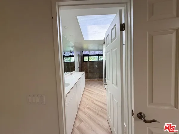 a view of a hallway with a livingroom and furniture