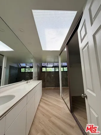 a kitchen with granite countertop a sink and cabinets