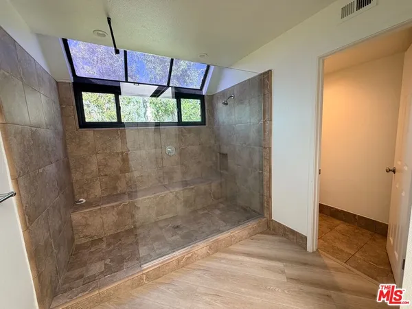 a bathroom with a bathtub and shower
