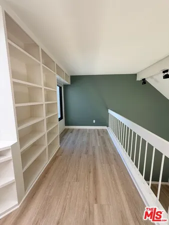 a view of a room with wooden floor and stairs