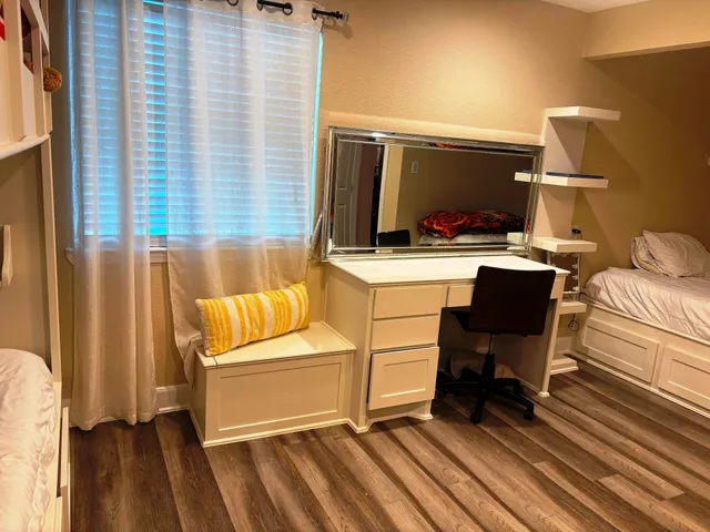 a view of a workspace with furniture and a window