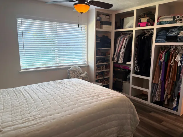 a bedroom with a bed and cabinets