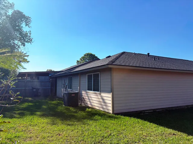 a view of house with backyard space and balcony