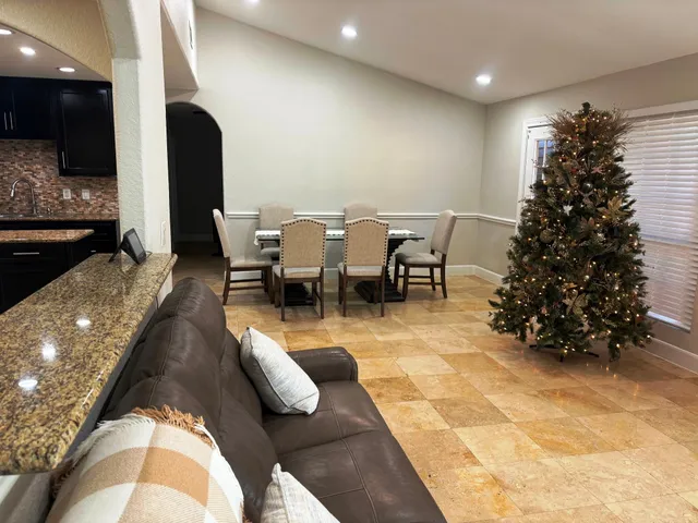 a living room with lots of furniture and a potted plant