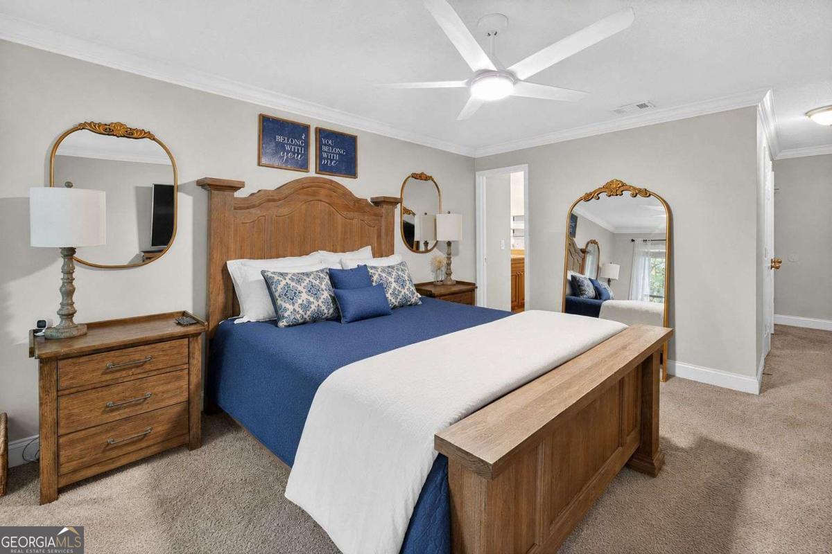 2514 Demere Road, Unit 7 St. Simons, GA 31522 - Photo 17 of 22 a bedroom with a bed and a mirror on dresser