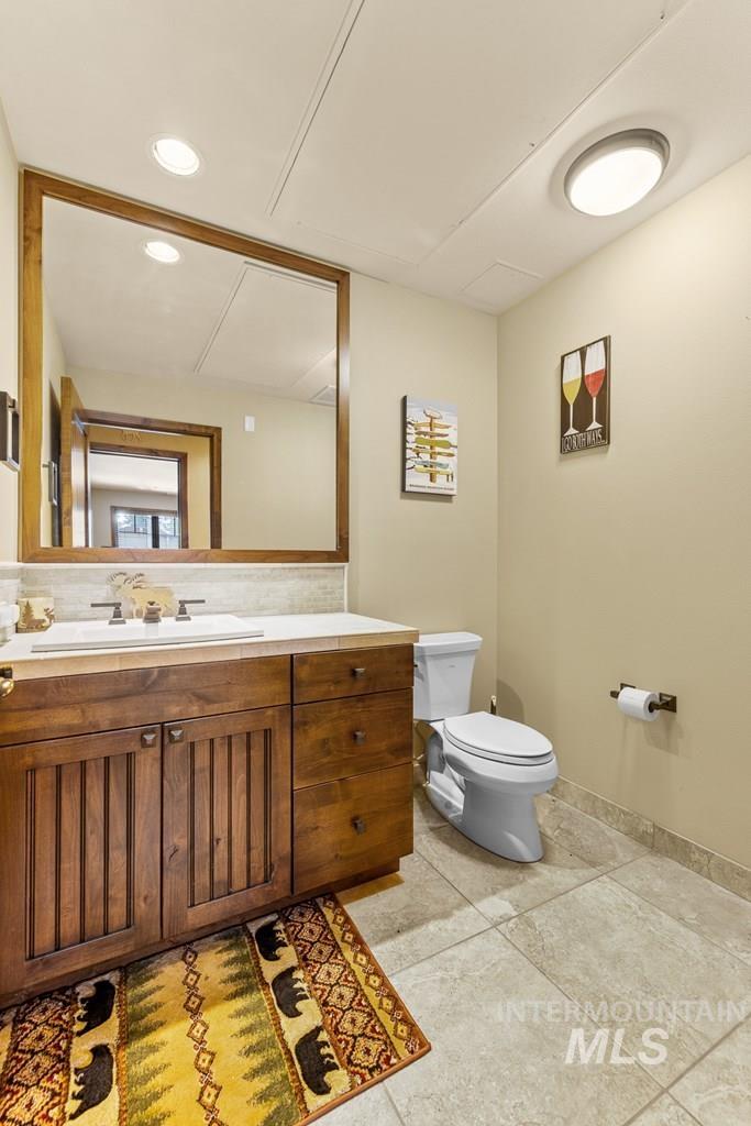 616 North 3rd Street, Unit 304 McCall, ID 83638 - Photo 11 of 38 Half bath featuring vanity, recessed lighting, and light tile patterned floors