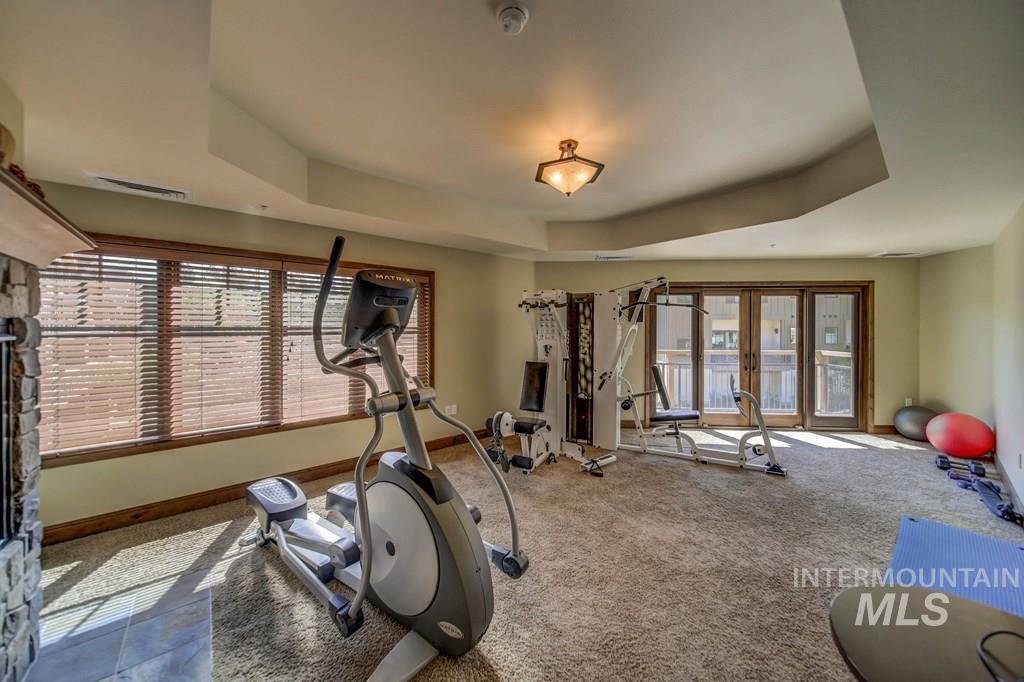 616 North 3rd Street, Unit 304 McCall, ID 83638 - Photo 3 of 38 Workout area featuring carpet, french doors, and a tray ceiling