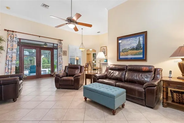 a living room with furniture and a large mirror