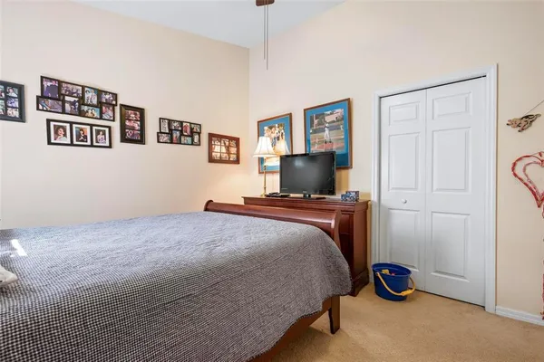 a bedroom with a bed lamps and a chandelier