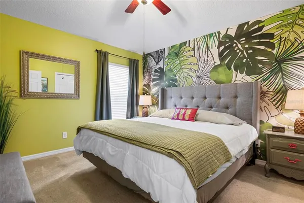 a bedroom with a bed and a painting on the wall