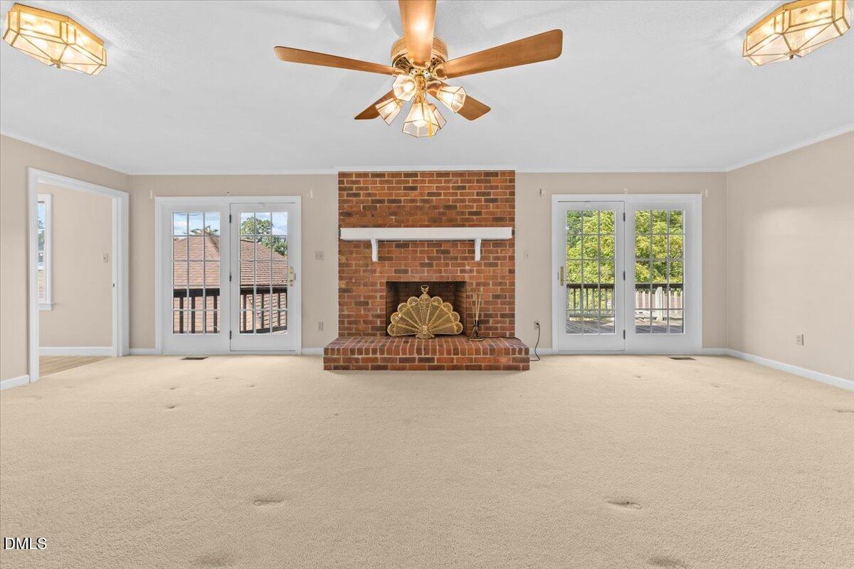 6464 Bonlee Road Bear Creek, NC 27207 - Photo 19 of 82 a view of an empty room with a fireplace and a large window