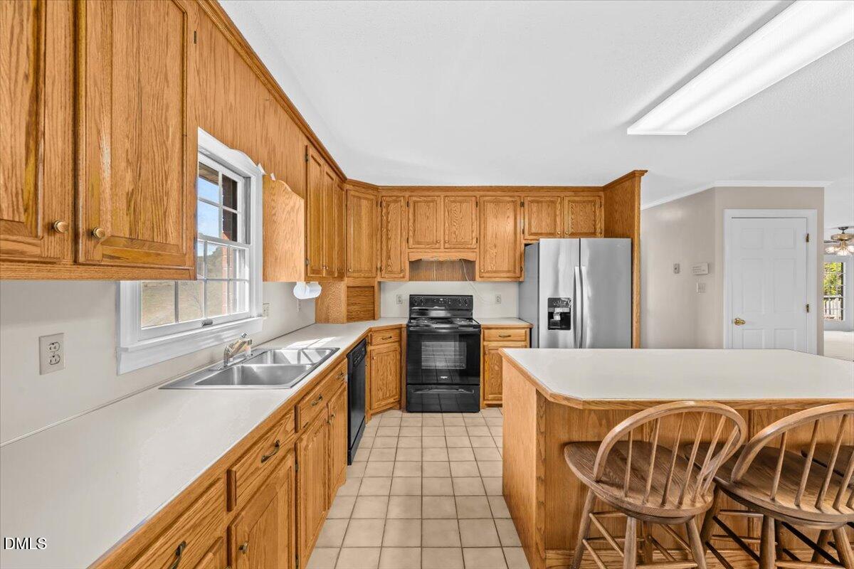 6464 Bonlee Road Bear Creek, NC 27207 - Photo 24 of 82 a kitchen with stainless steel appliances granite countertop a refrigerator and a stove top oven