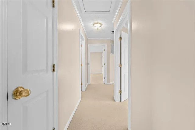 a view of an empty room with a window and fire place