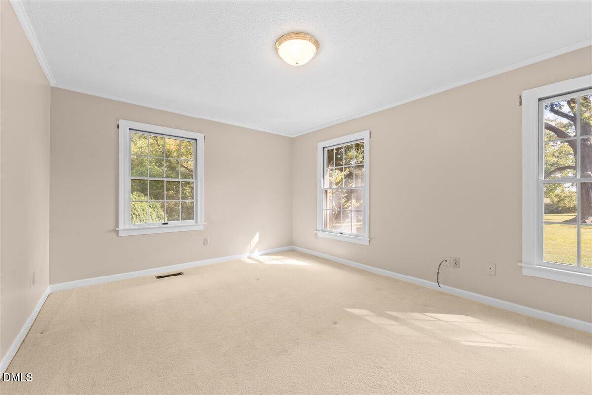 6464 Bonlee Road Bear Creek, NC 27207 - Photo 37 of 82 a view of an empty room with a window and wooden floor