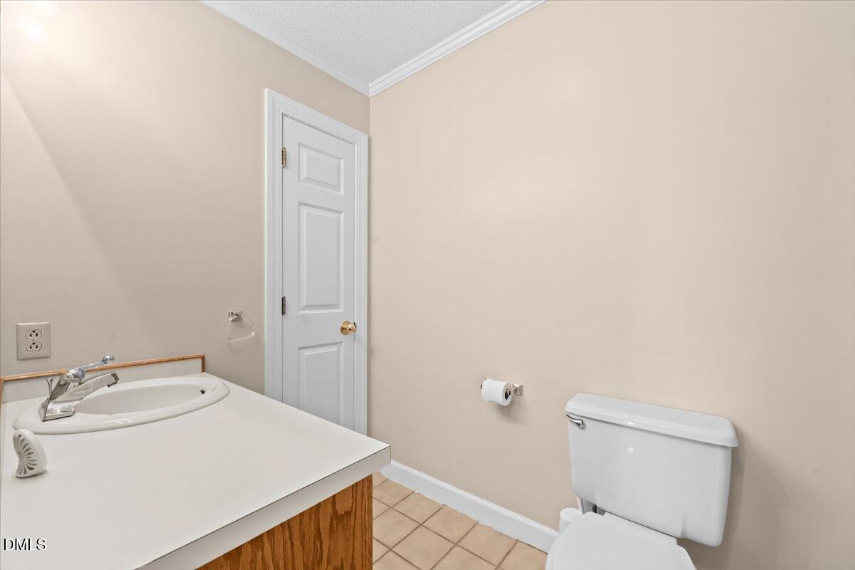6464 Bonlee Road Bear Creek, NC 27207 - Photo 41 of 82 a bathroom with a sink toilet and vanity