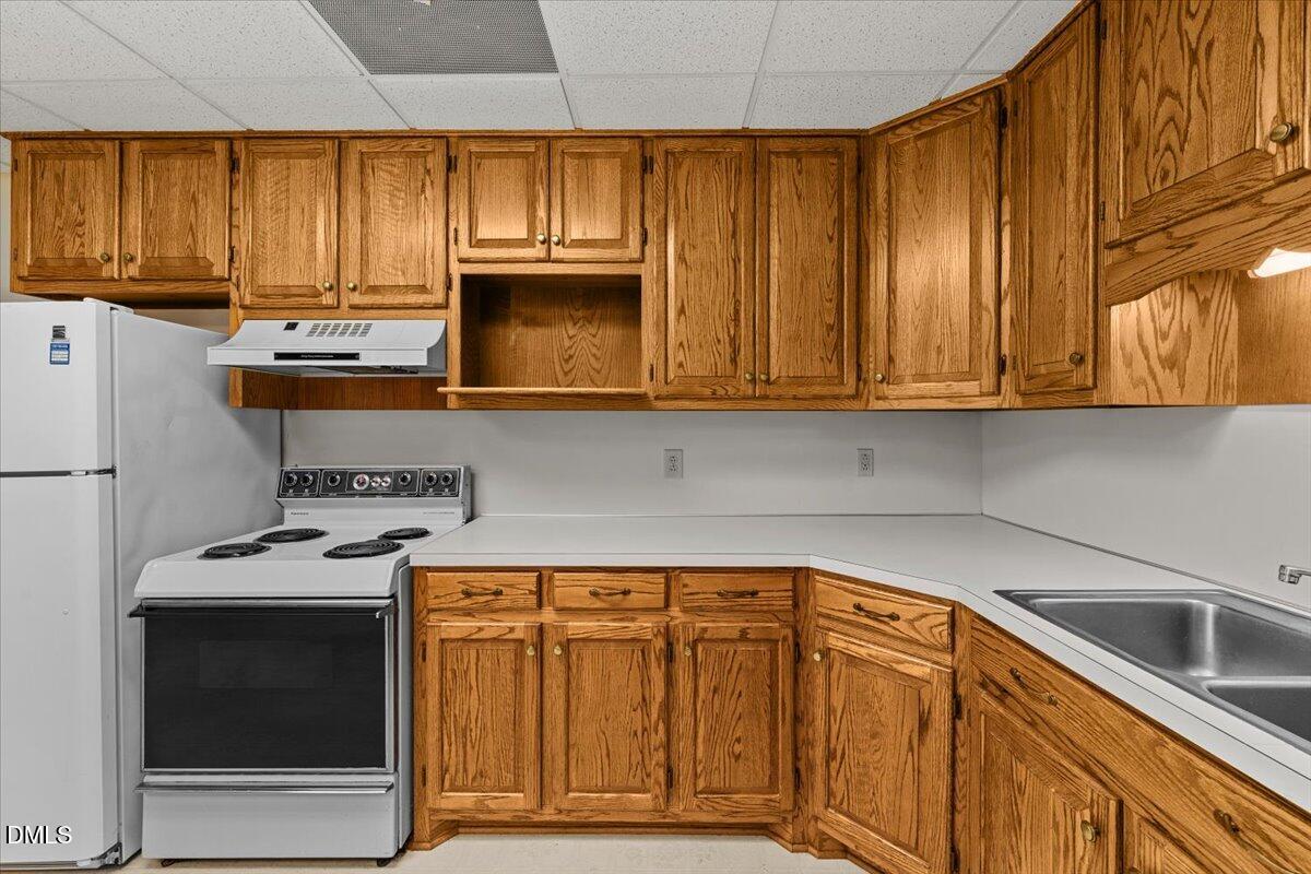 6464 Bonlee Road Bear Creek, NC 27207 - Photo 50 of 82 a kitchen with granite countertop wood cabinets stainless steel appliances and a sink