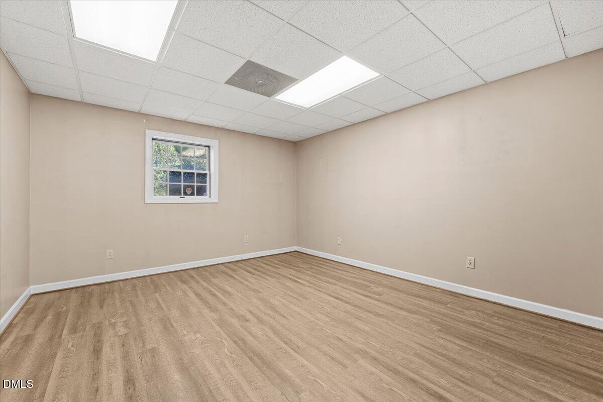 6464 Bonlee Road Bear Creek, NC 27207 - Photo 55 of 82 a view of an empty room with wooden floor and a window