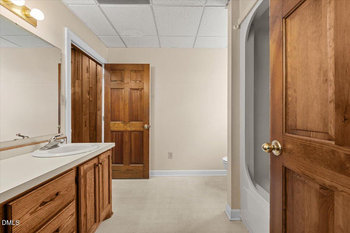 6464 Bonlee Road Bear Creek, NC 27207 - Photo 62 of 82 a bathroom with a sink a mirror and a shower