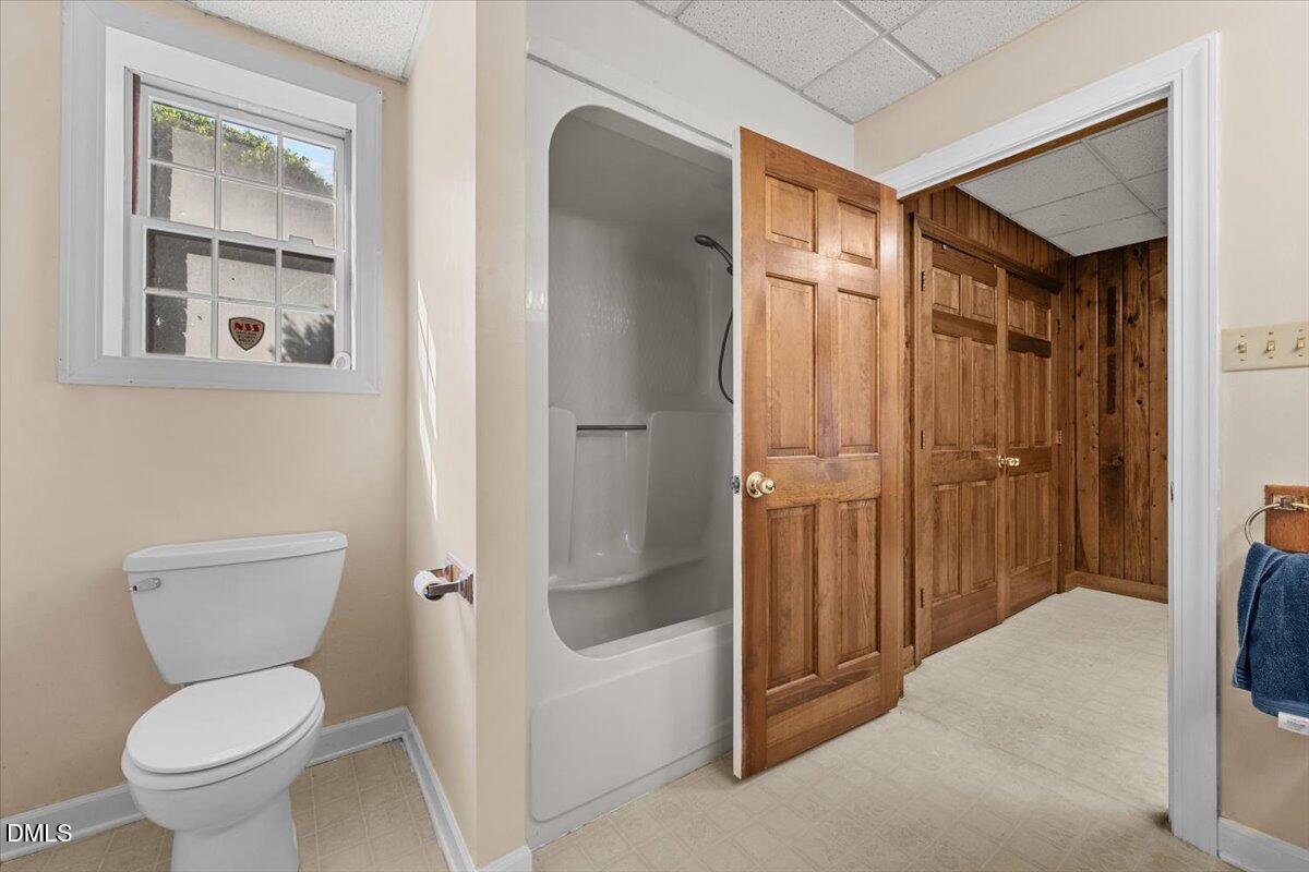 6464 Bonlee Road Bear Creek, NC 27207 - Photo 63 of 82 a bathroom with a granite countertop toilet a sink and bathtub