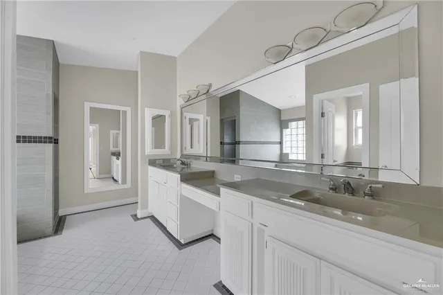 a bathroom with a tub shower and sink