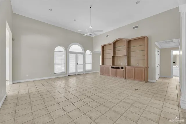 a view of a big room with windows and chandelier