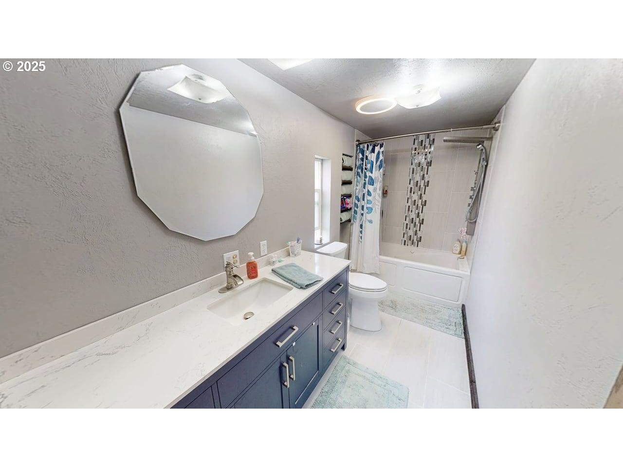 94120 Strahan Street, Unit 3 Gold Beach, OR 97444 - Photo 11 of 20 a bathroom with a sink a toilet and a mirror