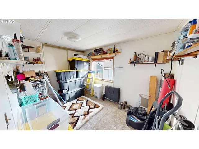 a living room with furniture and a gym machine
