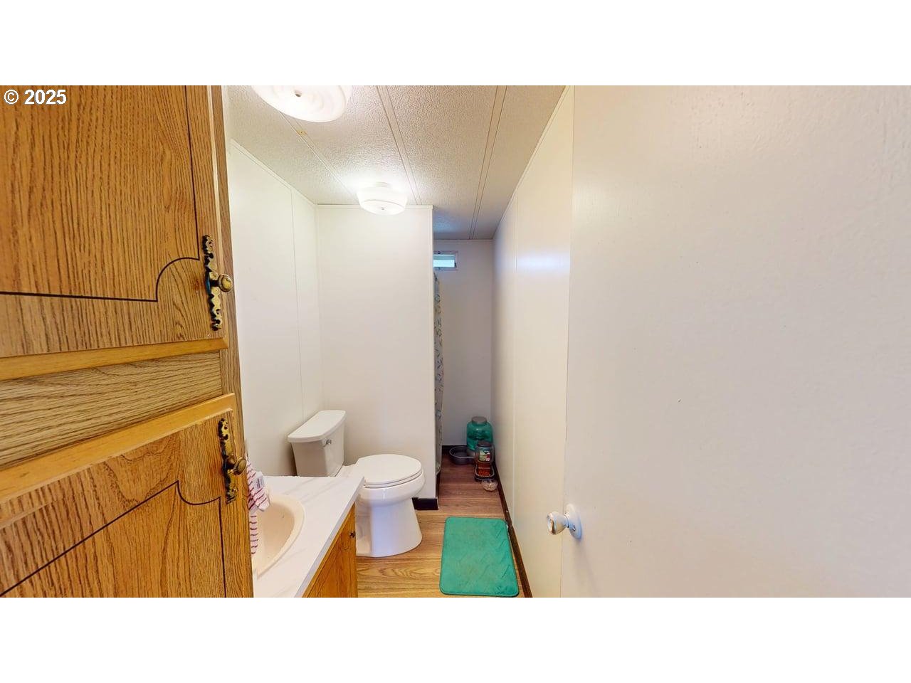 94120 Strahan Street, Unit 3 Gold Beach, OR 97444 - Photo 14 of 20 a bathroom with a sink toilet and shower