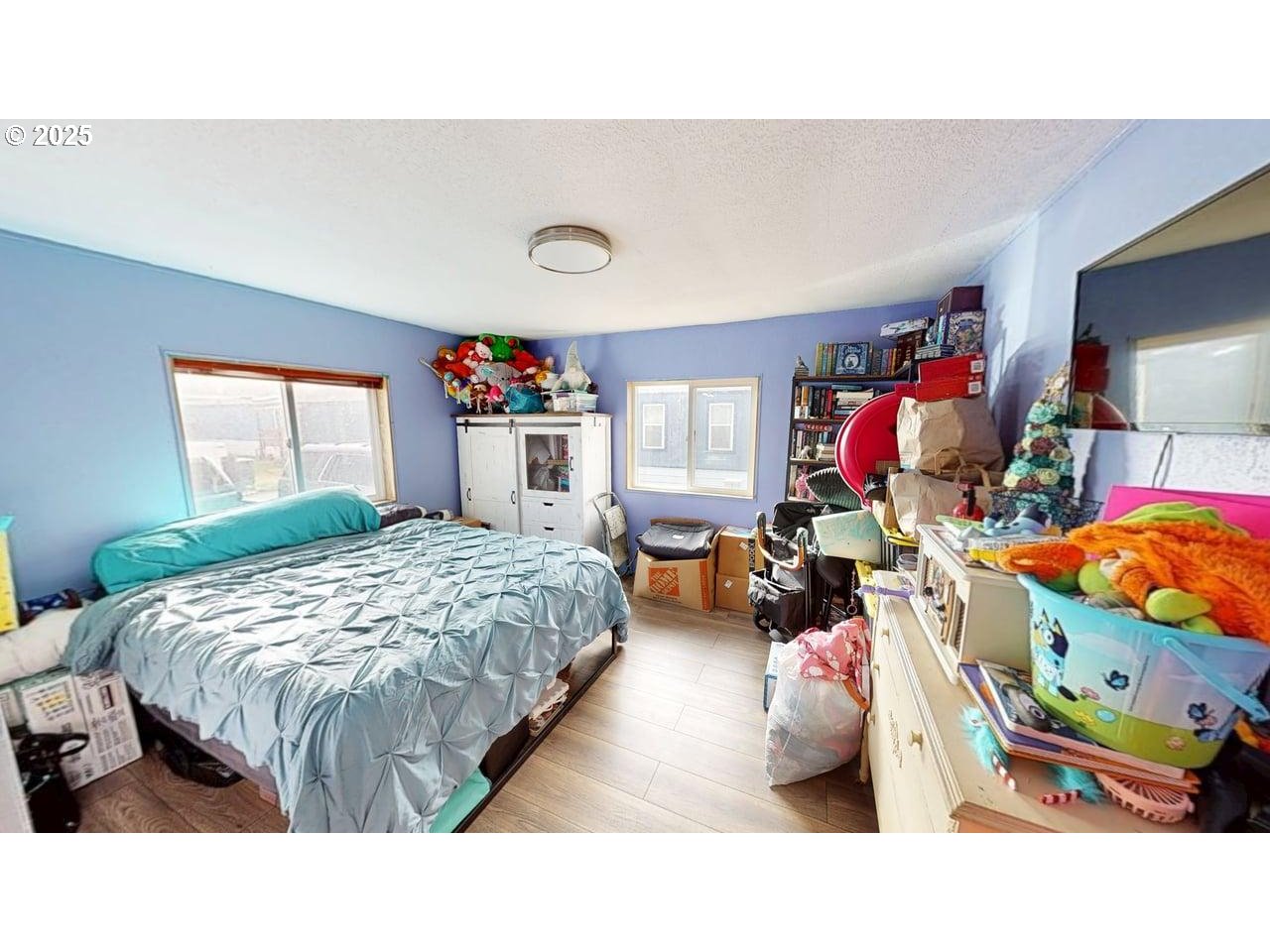 94120 Strahan Street, Unit 3 Gold Beach, OR 97444 - Photo 15 of 20 a bed room with a bed and a tv