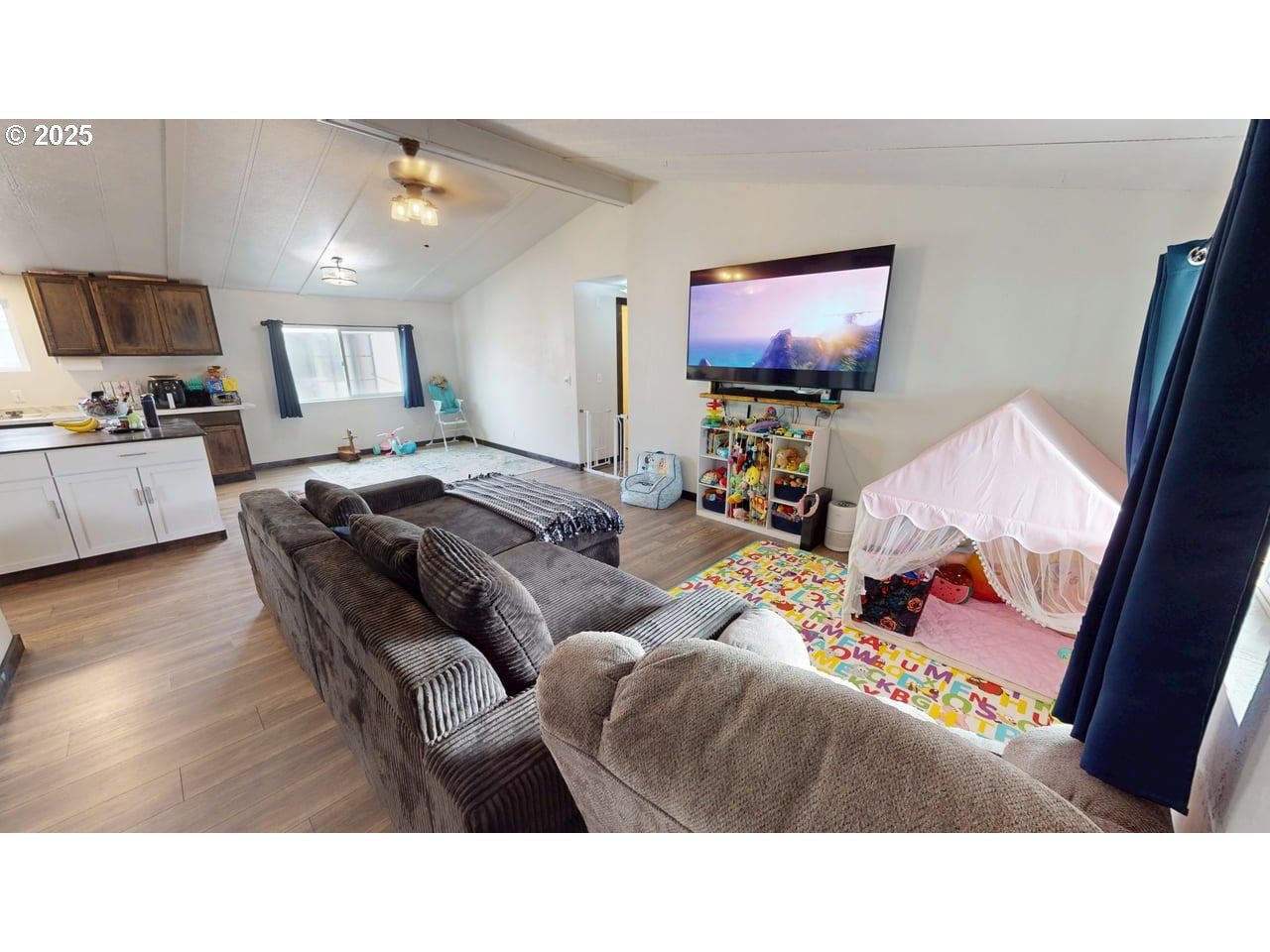 94120 Strahan Street, Unit 3 Gold Beach, OR 97444 - Photo 2 of 20 a living room with furniture and a flat screen tv