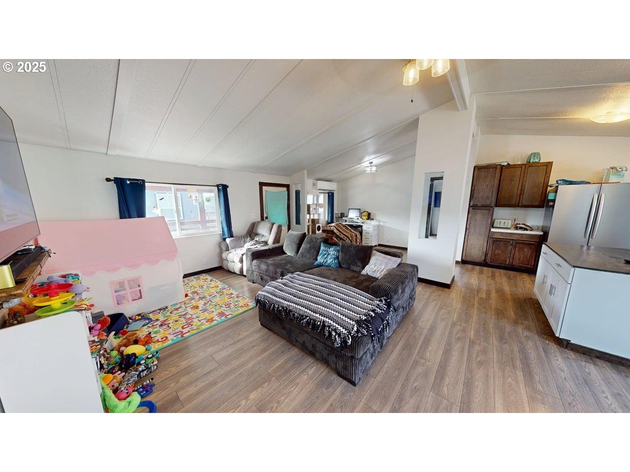 94120 Strahan Street, Unit 3 Gold Beach, OR 97444 - Photo 5 of 20 a living room with furniture and a wooden floor