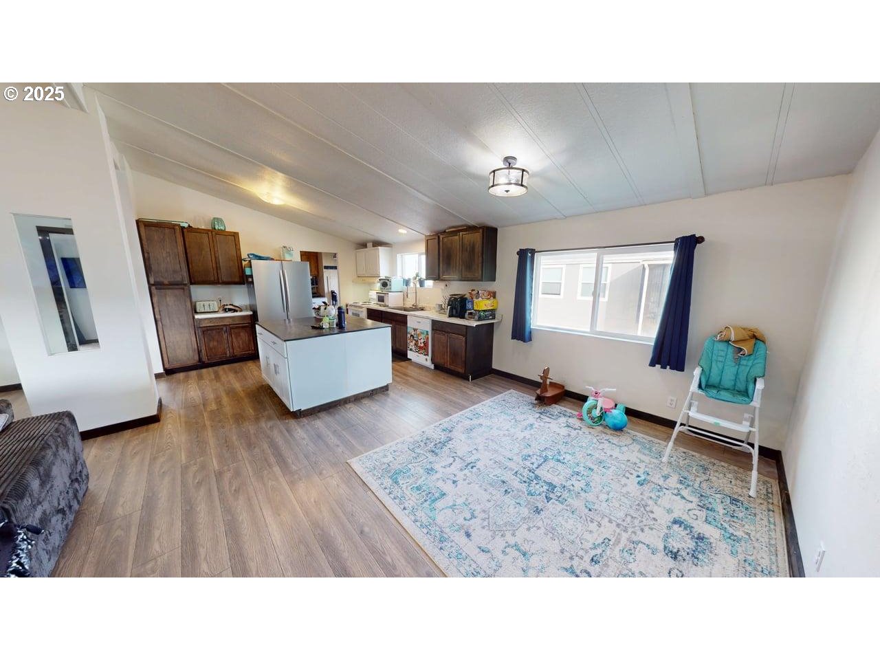 94120 Strahan Street, Unit 3 Gold Beach, OR 97444 - Photo 6 of 20 a living room with furniture and a wooden floor