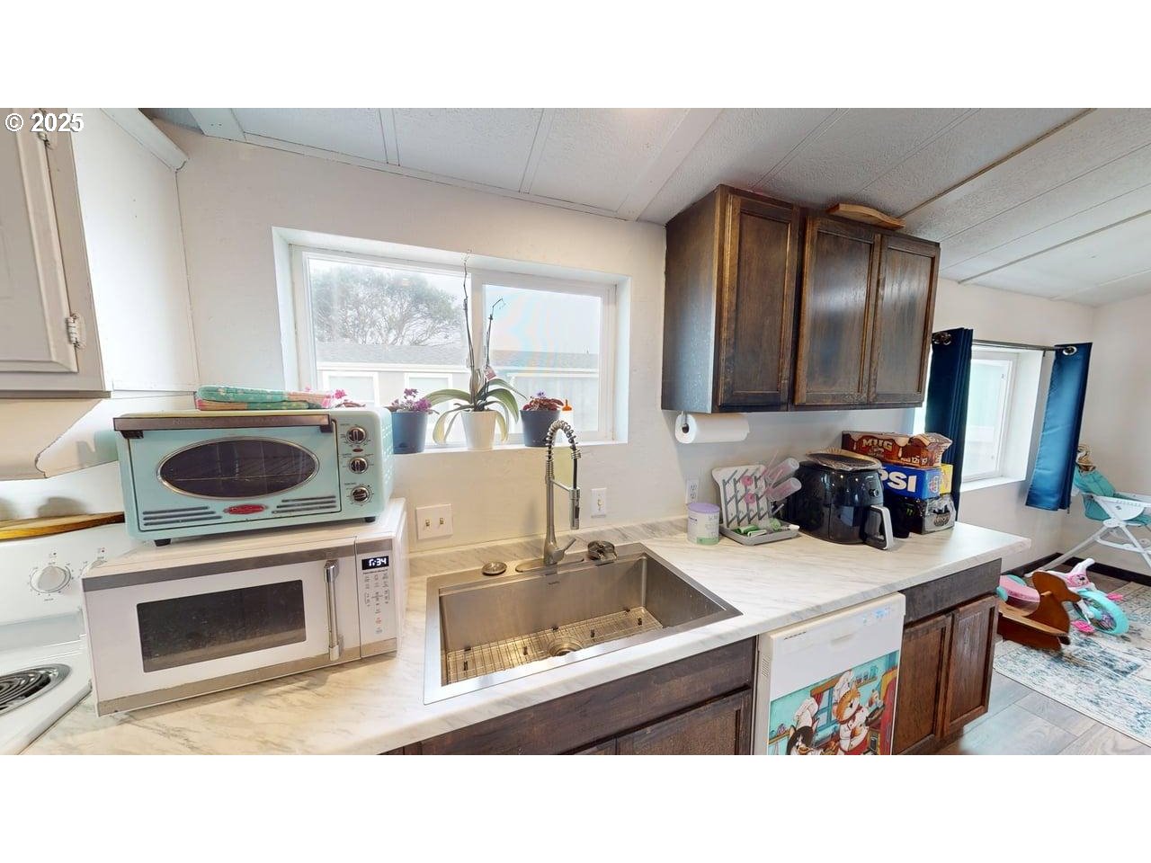 94120 Strahan Street, Unit 3 Gold Beach, OR 97444 - Photo 8 of 20 a kitchen with a stove a sink and a microwave