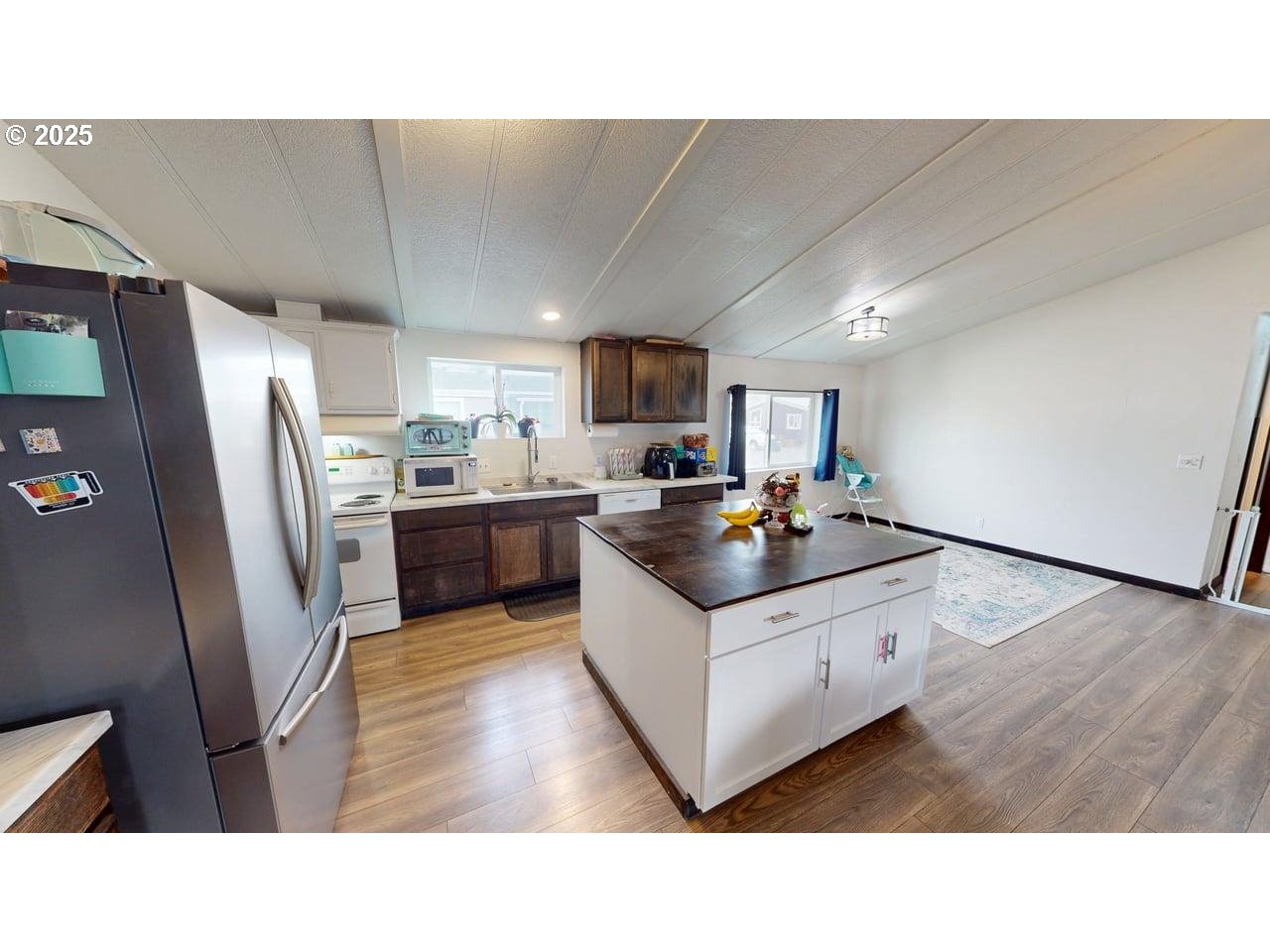 94120 Strahan Street, Unit 3 Gold Beach, OR 97444 - Photo 9 of 20 a kitchen with stainless steel appliances a sink a stove a refrigerator a microwave a sink and a refrigerator