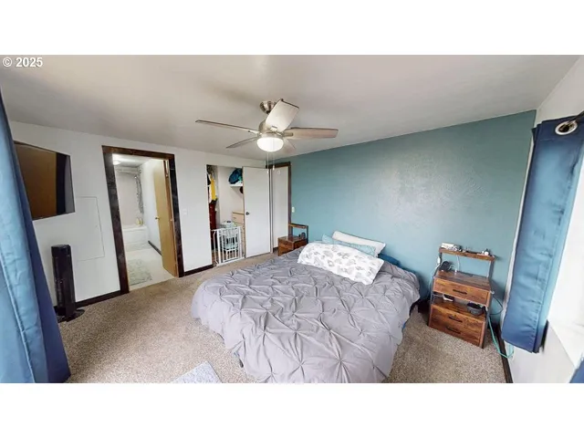 a living room with a bed furniture and a flat screen tv