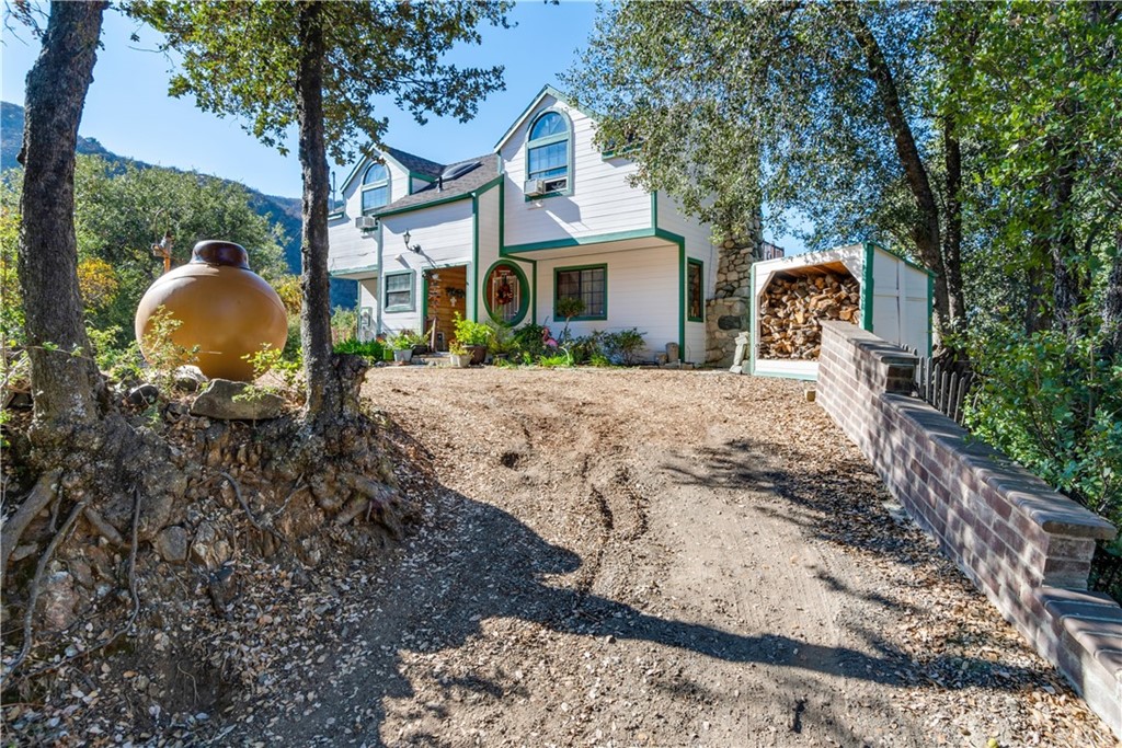 36998 Kilkare Road Yucaipa, CA 92399 - Photo 1 of 1 a front view of a house with a yard and large tree