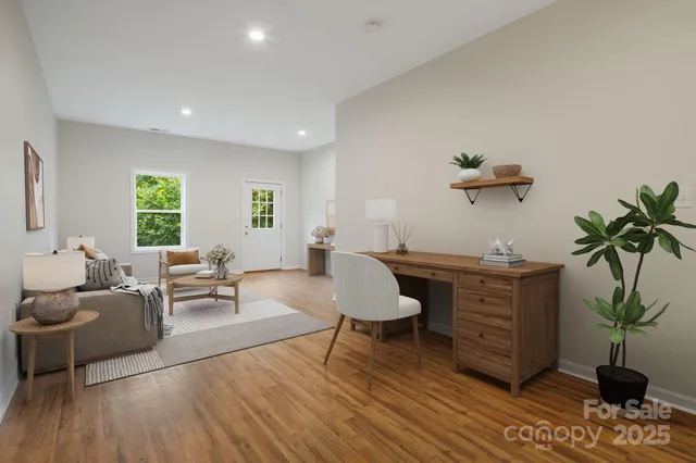 a living room with furniture a potted plant and a fireplace