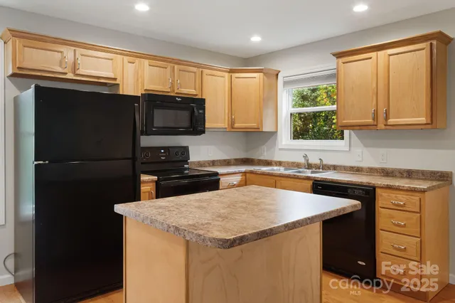 a kitchen with a stove a sink and a microwave
