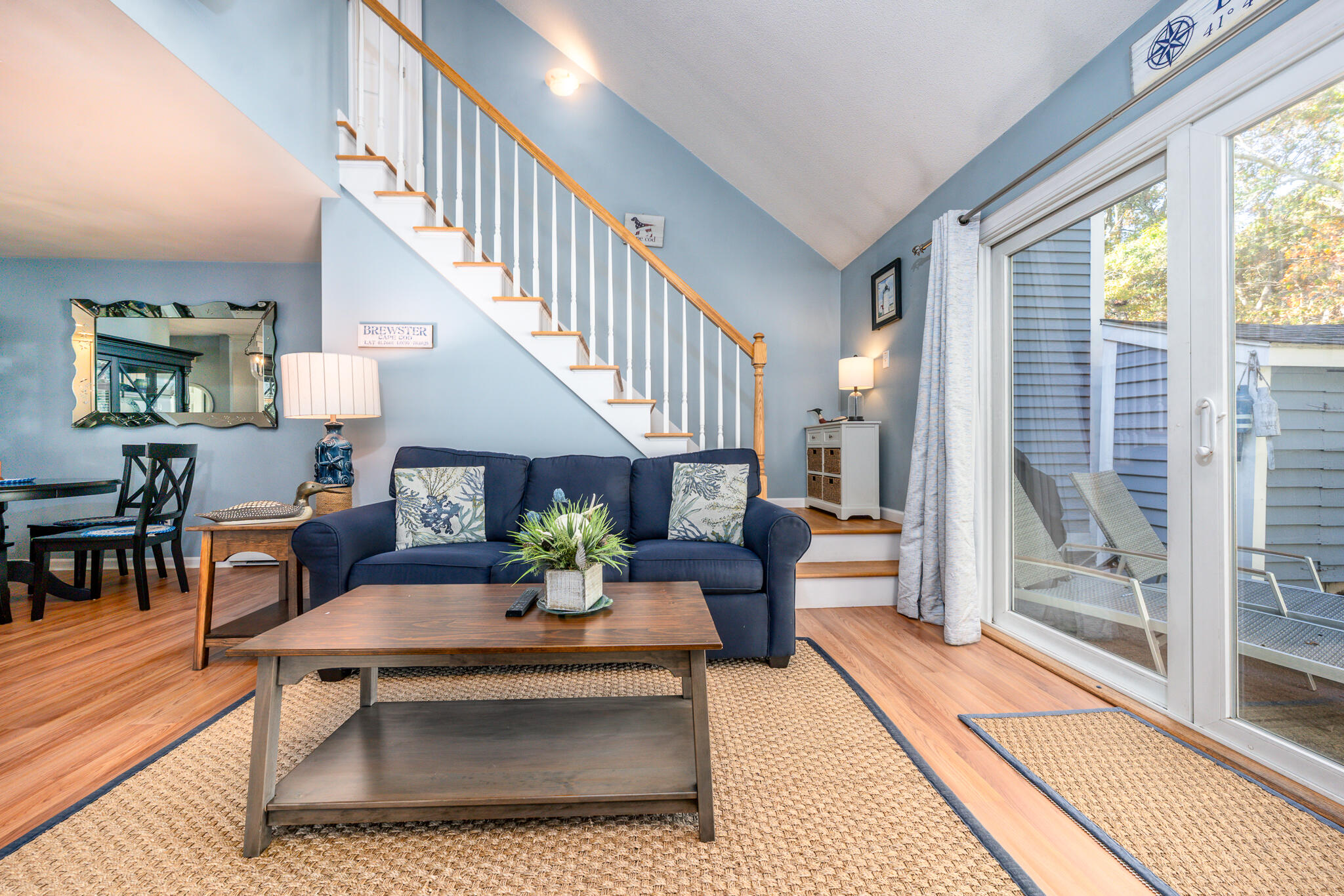 104 Howland Circle, Unit 104 Brewster, MA 02631 - Photo 11 of 29 a living room with furniture dining table and a large window