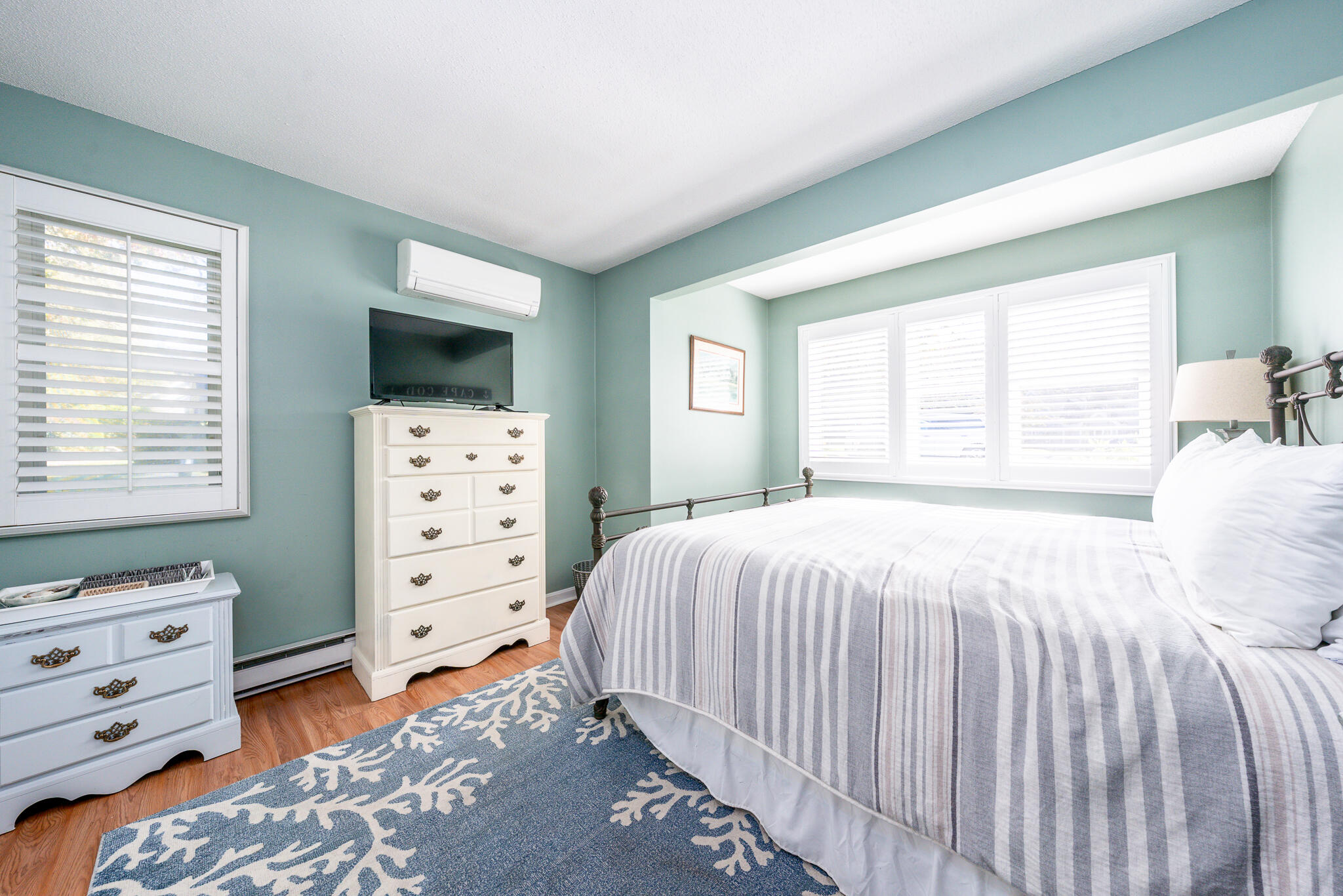104 Howland Circle, Unit 104 Brewster, MA 02631 - Photo 15 of 29 a bedroom with a bed and a dresser