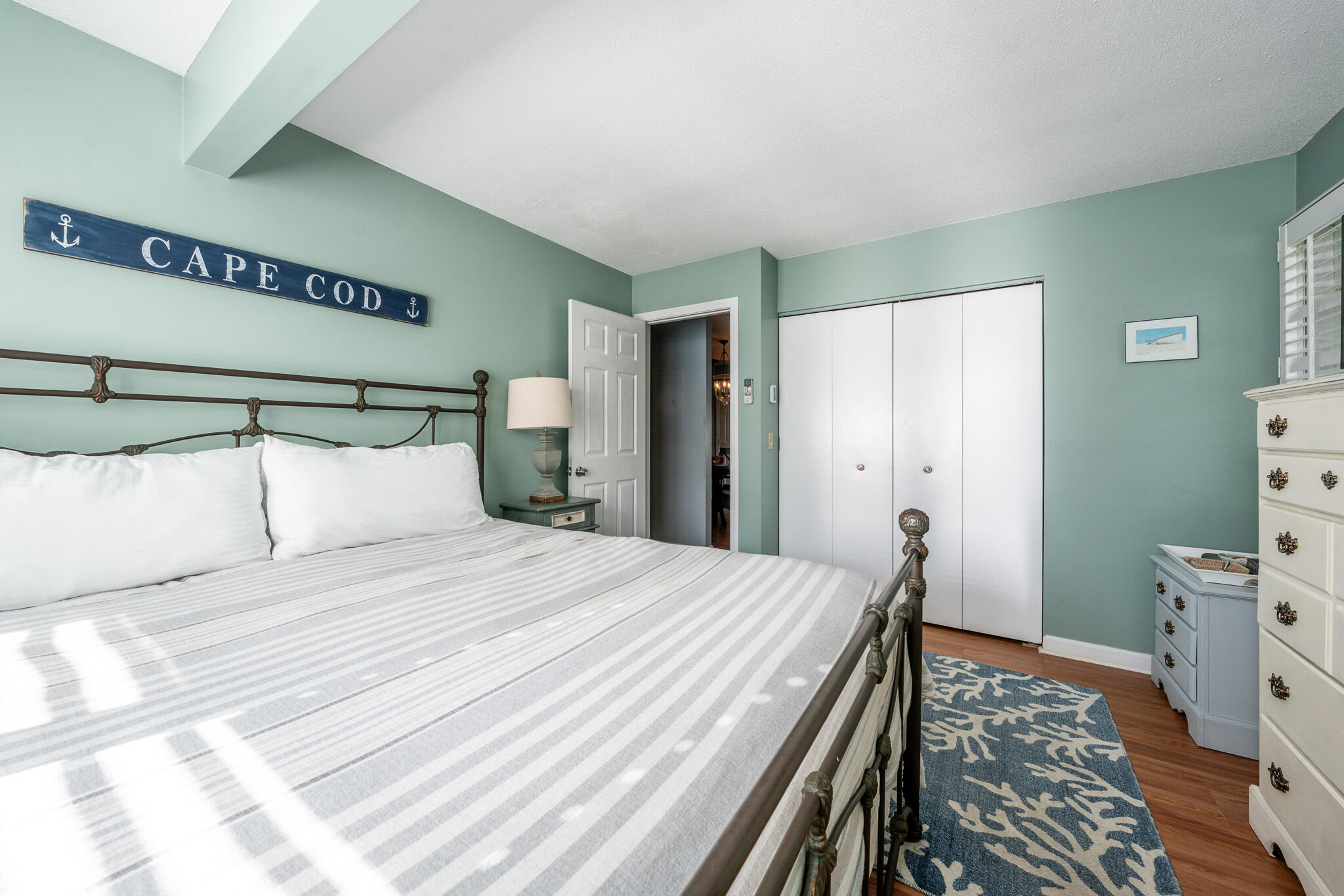 104 Howland Circle, Unit 104 Brewster, MA 02631 - Photo 17 of 29 a bedroom with a bed and a flat tv screen on dresser