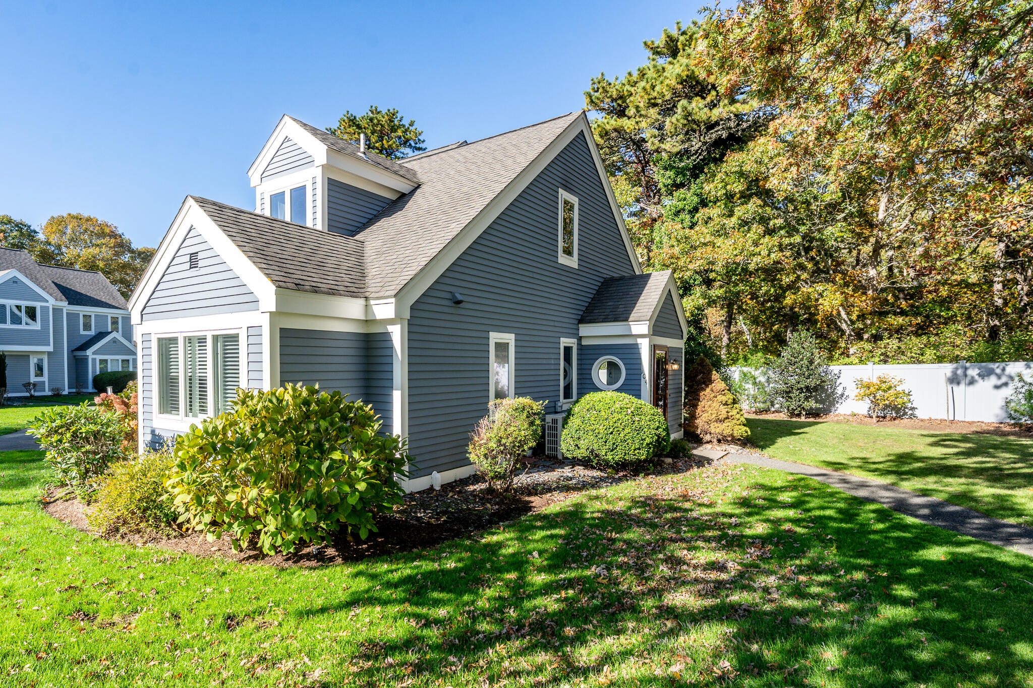 104 Howland Circle, Unit 104 Brewster, MA 02631 - Photo 2 of 29 a view of a house with a yard and potted plants