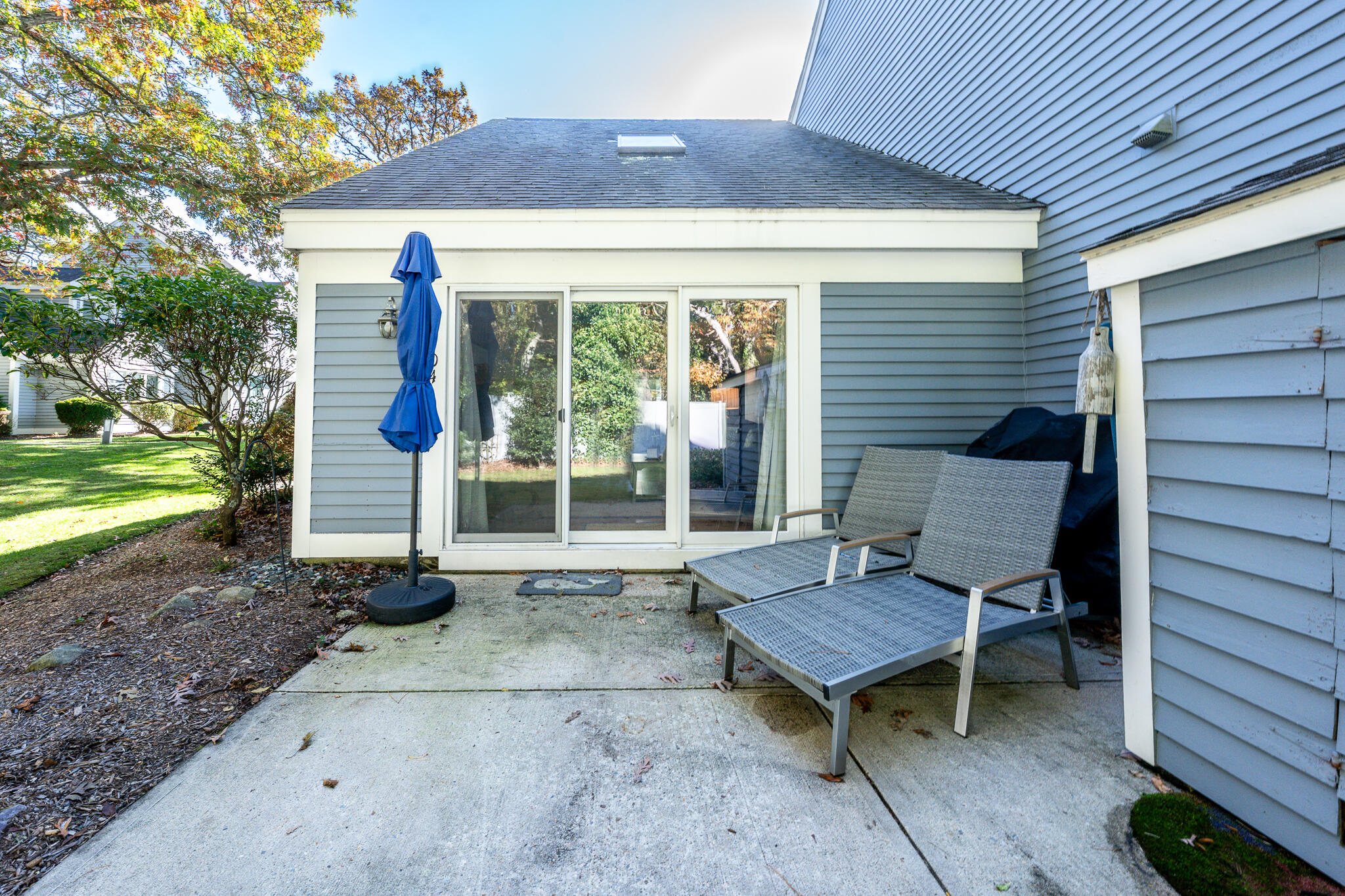 104 Howland Circle, Unit 104 Brewster, MA 02631 - Photo 24 of 29 a view of a chair and table in backyard of the house
