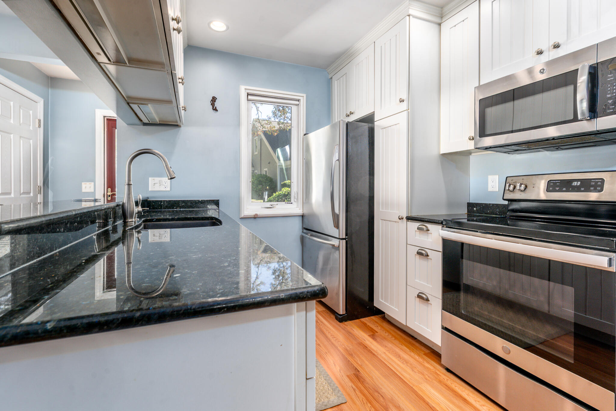 104 Howland Circle, Unit 104 Brewster, MA 02631 - Photo 6 of 29 a kitchen with a sink and stainless steel appliances